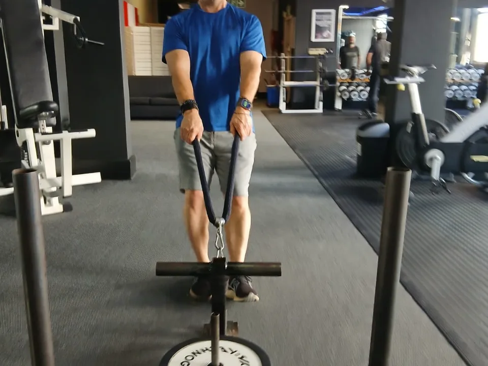 Athlete pulling a weighted sled during personal training at Iron Fists Academy